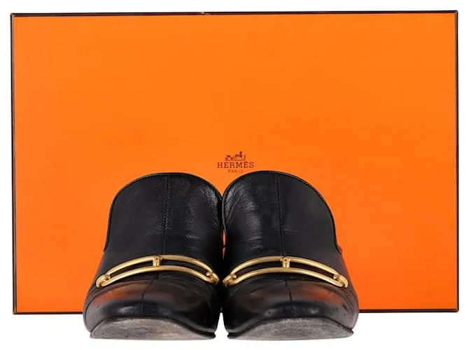 Mules Hermès Diane con hebilla Roulis en cuero de cabra negro 
